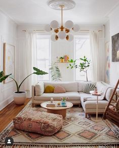 a living room filled with furniture and plants