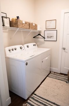 a white washer and dryer sitting in a laundry room next to a door