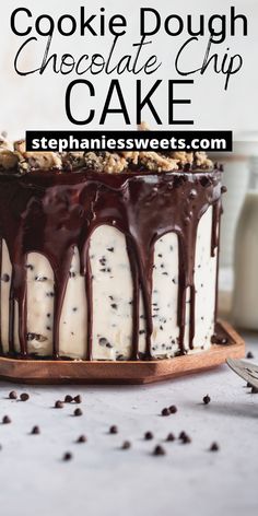 a close up of a cake on a plate with chocolate and white icing drizzled