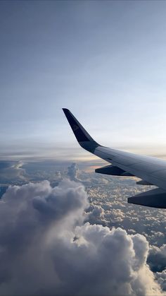 an airplane is flying high above the clouds