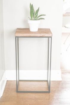 a small table with a plant on top