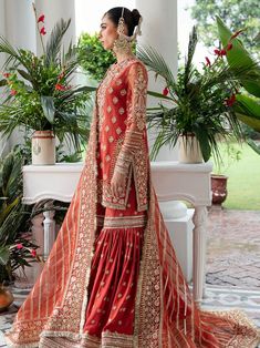 a woman in an orange lehenga and red dress