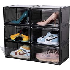 four pairs of shoes are stacked in a clear box on top of each other,