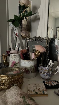 a desk with various items on it and a mirror in the back ground behind it