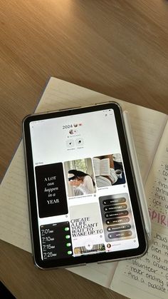 an open book and cell phone on a table