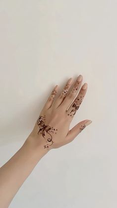 a woman's hand with tattoos on it