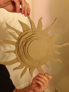 someone is making a sun out of cardboard