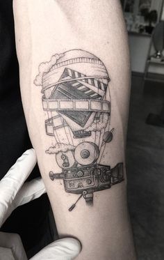 a black and white photo of a hot air balloon tattoo on the right arm,