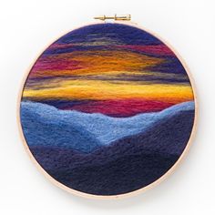 an embroidery project with mountains in the background