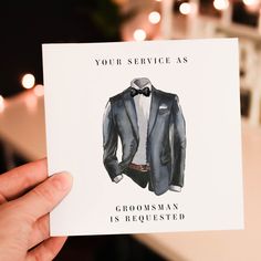 a person holding up a card with a suit on it