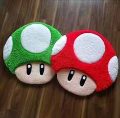 two mushroom rugs sitting on top of a wooden floor