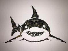 an origami shark mask with sharp teeth on it's face and mouth