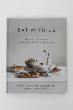 the book eat with us by phillip lago and mystice matai is on display