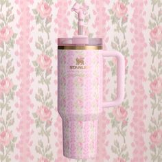 a pink and green floral wallpaper with a coffee cup in the shape of a mug