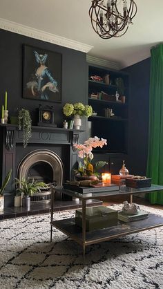 a living room filled with furniture and a fire place under a chandelier above a fireplace