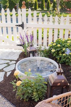 an outdoor fountain in the middle of a garden