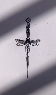 a black and white drawing of a dragonfly