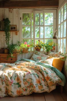 a bed sitting in a bedroom next to a window filled with potted plants on top of it