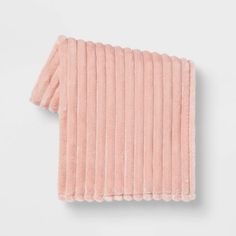 the rib knit scarf in pink is folded on top of a white surface and has an open