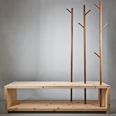 a wooden shelf with three trees on it