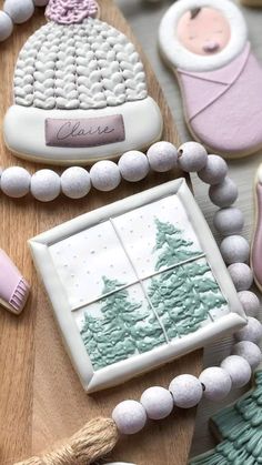 decorated cookies with frosting and icing on top of a wooden table next to other decorations