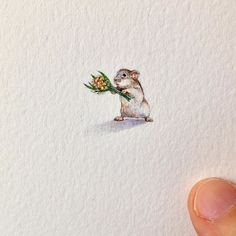 a drawing of a small rodent with a flower in it's mouth