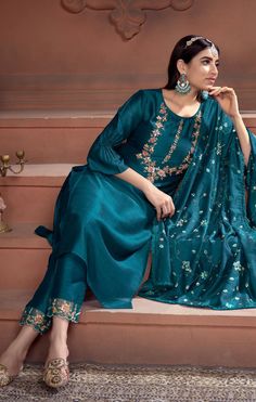 Add grace and charm towards the appearance in this Teal Blue Color silk trendy suit. The embroidery work within the attire adds a sign of elegance statement with a look. Comes with matching bottom and silk dupatta. This Suit is a suitable amalgamation of style and grace that is required from ethnic wear. The dress is ideal for any formal or informal gathering. Fabric Super silk Work Embroidery work Type Designer Readymade Top - Heavy Handwork on Super Silk with Inner. Pant - Super Silk Pant with Peacock Colour Suit, Peacock Colour Dress, Pink Indian Suit, Peacock Color Dress, Plazo Outfits, Blue Colour Suit, Gathering Fabric, Peacock Colour, Teal Suit