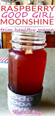 a mason jar filled with raspberry good girl moonshine on top of a table