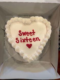 a heart shaped cake with the words sweet sixteen written on it in red and white frosting