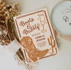 a card with the words boots and bullies on it next to some dried flowers