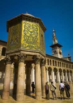 several people standing in front of an ornate building