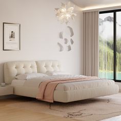 a white bed sitting in a bedroom on top of a hard wood floor next to a window