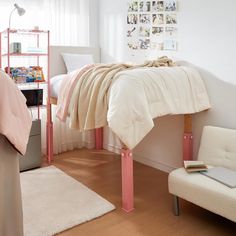 a bedroom with a bed, desk and chair in it