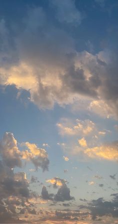 an airplane is flying in the sky at sunset