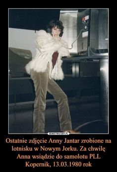 a woman in white fur coat standing next to a microwave oven and talking on a cell phone