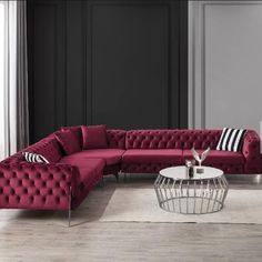 a living room with a red couch and white table