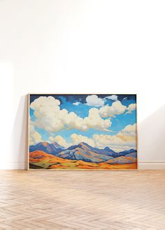 an empty room with a painting on the wall and hard wood flooring in front of it