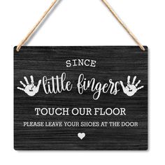 a sign that says, since little fingers touch our floor please leave your shoes at the door