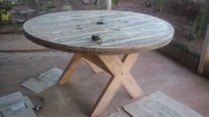 a wooden table sitting on top of a cement floor