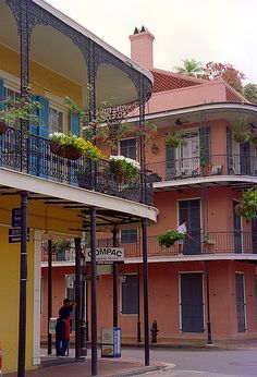 an apartment building with balconies and flowers on the balcony