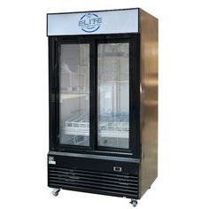 a black and silver refrigerator sitting on top of a white floor next to a metal cabinet