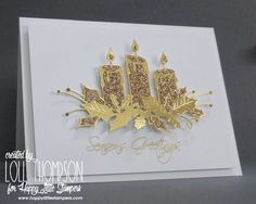 a close up of a greeting card with candles and leaves on the front, in gold