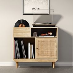 a record player sitting on top of a wooden cabinet