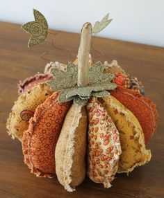 a small decorative pumpkin sitting on top of a wooden table