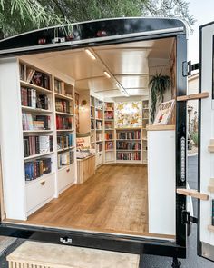 an open door to a book store with bookshelves and shelves on both sides