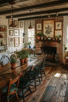 a dining room table with chairs and potted plants on top of it in front of a fire place