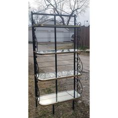 three tiered metal shelf with glass shelves in the middle and one on each side