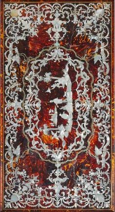 an intricately designed red and white rug