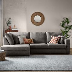 a living room filled with furniture and a round mirror