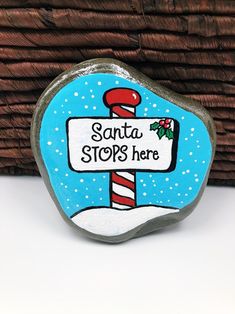 a rock with a sign that says santa stops here